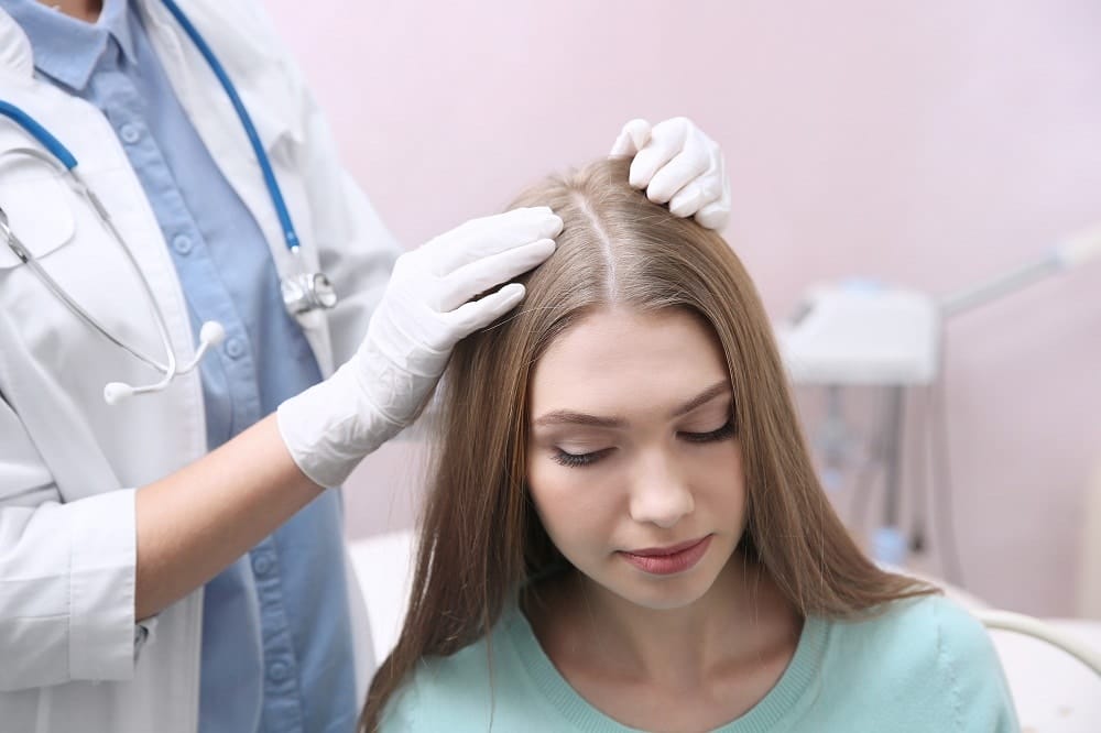 Doctor examining scalp